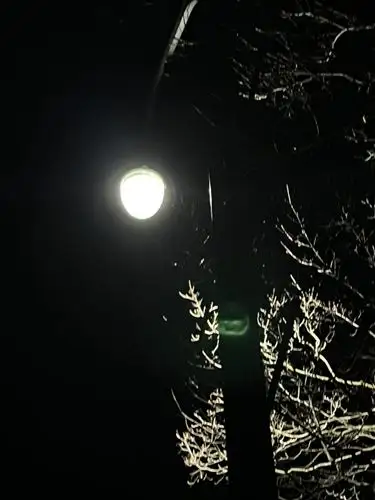 A single light pierces the deep night.
